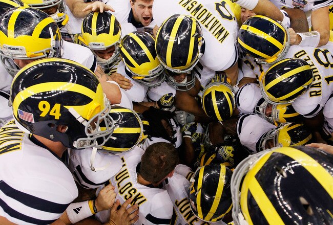 NEW ORLEANS, LA - JANUARY 03:  The Michigan Wolverines pile on kicker Brendan Gibbons #34 after Gibbons kicked a successful 37-yard game-winning field goal in overtime against the Virginia Tech Hokies during the Allstate Sugar Bowl at Mercedes-Benz Superdome on January 3, 2012 in New Orleans, Louisiana.  (Photo by Kevin C. Cox/Getty Images)