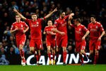 MANCHESTER, ENGLAND - JANUARY 11:  Steven Gerrard of Liverpool celebrates scoring the opening goal from a penalty kick with his team mates during the Carling Cup Semi Final First Leg match between Manchester City and Liverpool at the Etihad Stadium on January 11, 2012 in Manchester, England.  (Photo by Laurence Griffiths/Getty Images)