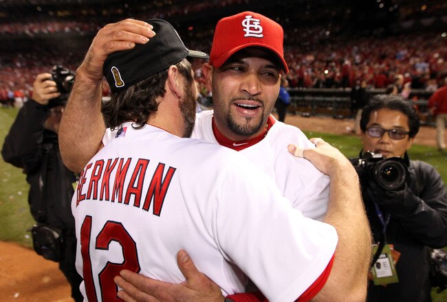 ST LOUIS, MO - OCTOBER 28:  Albert Pujols #5 (R) and Lance Berkman #12 of the St. Louis Cardinals celebrate after defeating the Texas Rangers 6-2 in Game Seven of the MLB World Series at Busch Stadium on October 28, 2011 in St Louis, Missouri.  (Photo by Jamie Squire/Getty Images)
