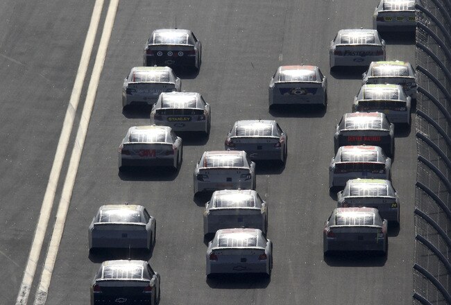 DAYTONA BEACH, FL - JANUARY 14:  A group of cars race during Daytona Preseason Thunder at Daytona International Speedway on January 14, 2012 in Daytona Beach, Florida.  (Photo by Jerry Markland/Getty Images for NASCAR)