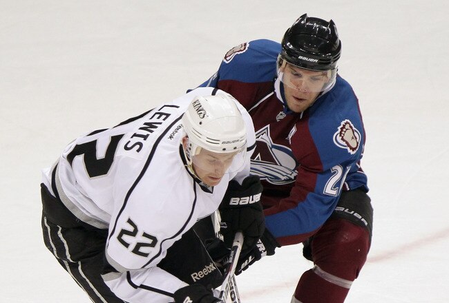 DENVER, CO - SEPTEMBER 28:  Trevor Lewis #22 of the Los Angeles Kings and Paul Stastny #26 of the Colorado Avalanche battle for control of the puck during preseason action at the Pepsi Center on September 28, 2011 in Denver, Colorado. The Kings defeated the Avalanche 6-0.  (Photo by Doug Pensinger/Getty Images)