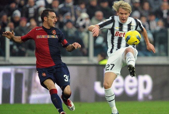 TURIN, ITALY - JANUARY 15:  Milos Krasic (R) of Juventus FC in action against Alessandro Agostini of Cagliari Calcio during the Serie A match between Juventus FC and Cagliari Calcio at Juventus Arena on January 15, 2012 in Turin, Italy.  (Photo by Valerio Pennicino/Getty Images)