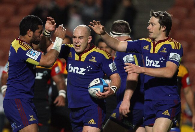 HAMILTON, NEW ZEALAND - MAY 07: Jason Rutledge of the Highlanders celebrates with Alando Soakai and Ben Smith after scoring during the round 12 Super Rugby match between the Chiefs and the Highlanders at Waikato Stadium on May 7, 2011 in Hamilton, New Zealand.  (Photo by Hannah Johnston/Getty Images)
