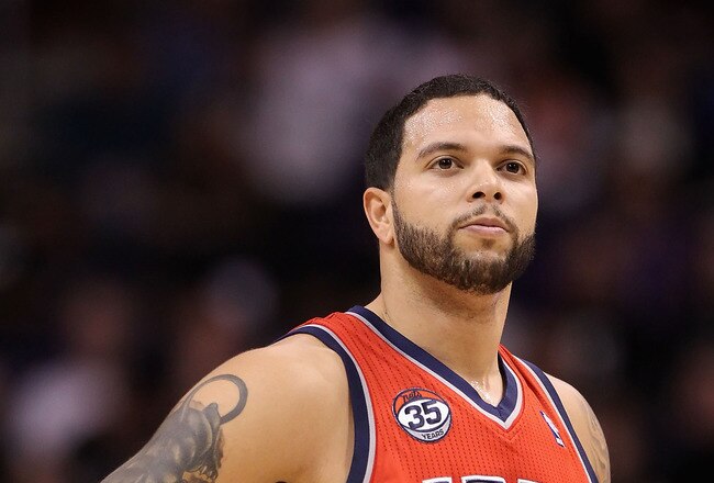 PHOENIX, AZ - JANUARY 13:  Deron Williams #8 of the New Jersey Nets in action during the NBA game against the Phoenix Suns at US Airways Center on January 13, 2012 in Phoenix, Arizona. The Nets defeated the Suns 110-103.   NOTE TO USER: User expressly acknowledges and agrees that, by downloading and or using this photograph, User is consenting to the terms and conditions of the Getty Images License Agreement.  (Photo by Christian Petersen/Getty Images)