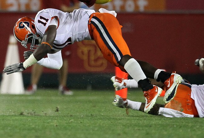 LOS ANGELES - SEPTEMBER 17:  Fullback Rhett Ellison #40 of the USC Trojans is upended by linebacker Marquis Spruill # 11 of the Syracuse Orangemen at the Los Angeles Memorial Coliseum on September 17, 2011 in Los Angeles, California.  (Photo by Stephen Dunn/Getty Images)