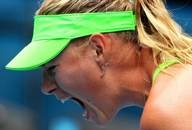 MELBOURNE, AUSTRALIA - JANUARY 21: (EDITORS NOTE: retransmit of Image 137445668.jpg with alternate crop) Maria Sharapova of Russia celebrates winning her third round match against Angelique Kerber of Germany during day six of the 2012 Australian Open at Melbourne Park on January 21, 2012 in Melbourne, Australia.  (Photo by Lucas Dawson/Getty Images)