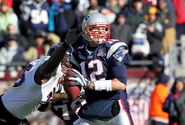 FOXBORO, MA - JANUARY 10:  Tom Brady #12 of the New England Patriots looks to pass against pressure from Terrell Suggs #55 of the Baltimore Ravens during the 2010 AFC wild-card playoff game at Gillette Stadium on January 10, 2010 in Foxboro, Massachusetts. The Ravens won 33-14.  (Photo by Jim Rogash/Getty Images)