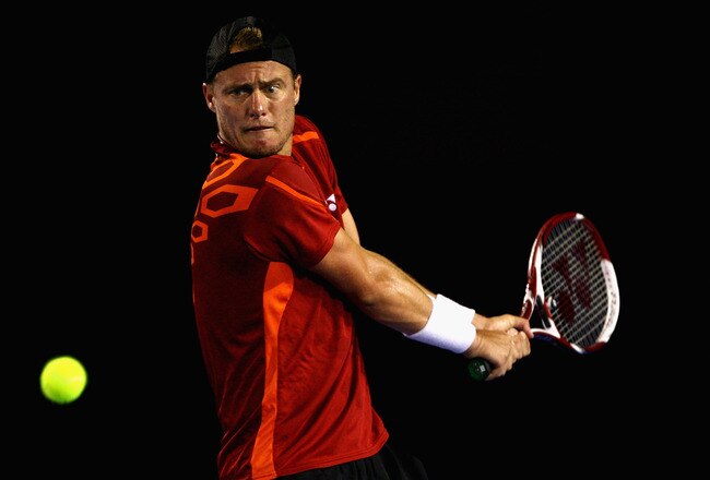 MELBOURNE, AUSTRALIA - JANUARY 21:  Lleyton Hewitt of Australia plays a backhand in his third round match against Milos Raonic of Canada during day six of the 2012 Australian Open at Melbourne Park on January 21, 2012 in Melbourne, Australia.  (Photo by Robert Prezioso/Getty Images)