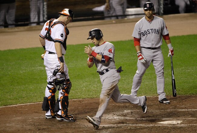 BALTIMORE, MD - SEPTEMBER 28:  Catcher Matt Wieters #32 of the Baltimore Orioles and Mike Aviles #3 of the Boston Red Sox look on as Marco Scutaro #10 (C) celebrates after scocring on a balk during the fourth inning at Oriole Park at Camden Yards on September 28, 2011 in Baltimore, Maryland.  (Photo by Rob Carr/Getty Images)