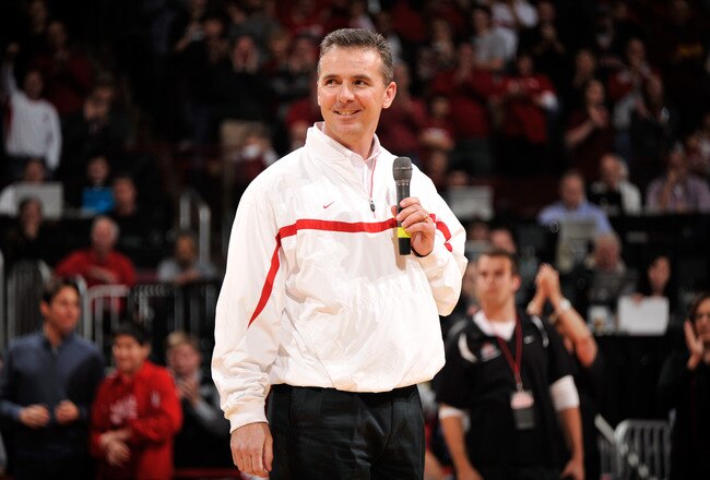COLUMBUS, OH - JANUARY 15:  Head football coach Urban Meyer of the Ohio State Buckeyes is introduced to the crowd at halftime of the basketball game between the Indiana Hoosiers and the Ohio State Buckeyes on January 15, 2012 at Value City Arena in Columbus, Ohio.  (Photo by Jamie Sabau/Getty Images)