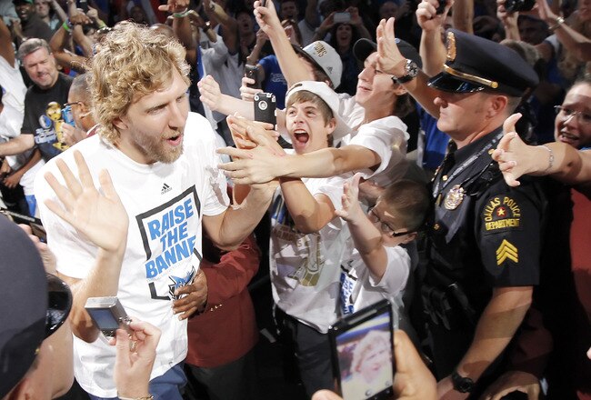 DALLAS, TX - JUNE 16: Forward Dirk Nowitzki of the Dallas Mavericks high fives fans during the Dallas Mavericks Victory celebration on June 16, 2011 in Dallas, Texas. (Photo by Brandon Wade/Getty Images)