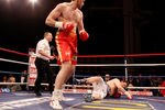 LIVERPOOL, ENGLAND - JANUARY 21:  David Price knocks down John McDermott during their British and Commonwealth Heavyweight Title Eliminator at Liverpool Olympia on January 21, 2012 in Liverpool, England.  (Photo by Scott Heavey/Getty Images)