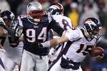 FOXBORO, MA - JANUARY 14:  Shaun Ellis #94 of the New England Patriots sackes Tim Tebow #15 of the Denver Broncos during their AFC Divisional Playoff Game at Gillette Stadium on January 14, 2012 in Foxboro, Massachusetts.  (Photo by Elsa/Getty Images)