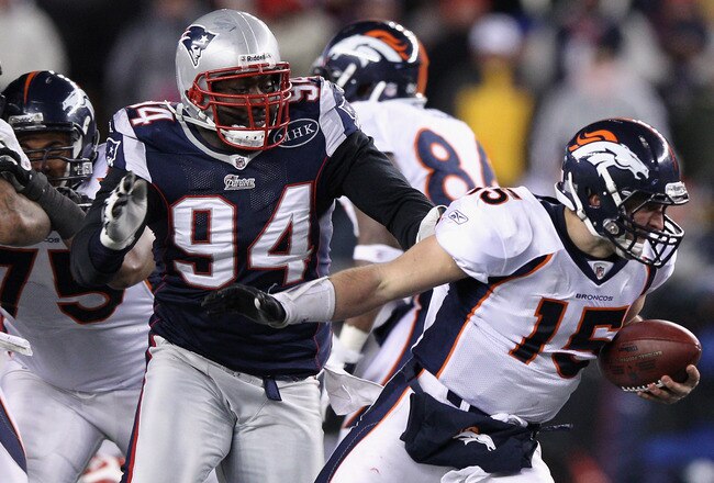 FOXBORO, MA - JANUARY 14:  Shaun Ellis #94 of the New England Patriots sackes Tim Tebow #15 of the Denver Broncos during their AFC Divisional Playoff Game at Gillette Stadium on January 14, 2012 in Foxboro, Massachusetts.  (Photo by Elsa/Getty Images)
