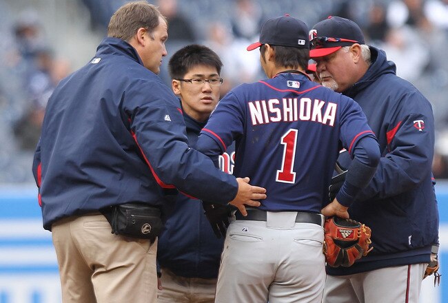NEW YORK, NY - APRIL 07:  Tsuyoshi Nishioka #1 of the Minnesota Twins leaves the game injured after being hit by Nick Swisher #33 of the New York Yankees at Yankee Stadium on April 7, 2011 in the Bronx borough of New York City.  (Photo by Nick Laham/Getty Images)