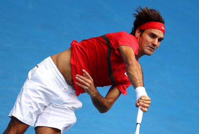 MELBOURNE, AUSTRALIA - JANUARY 20:  Roger Federer of Switzerland serves in his third round match against Ivo Karlovic of Croatia during day five of the 2012 Australian Open at Melbourne Park on January 20, 2012 in Melbourne, Australia.  (Photo by Clive Brunskill/Getty Images)