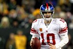 GREEN BAY, WI - JANUARY 15:  Eli Manning #10 of the New York Giants looks to pass against the Green Bay Packers during their NFC Divisional playoff game at Lambeau Field on January 15, 2012 in Green Bay, Wisconsin.  (Photo by Jamie Squire/Getty Images)