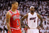 MIAMI, FL - MAY 22:  LeBron James (R) #6 of the Miami Heat looks on as Derrick Rose #1 of the Chicago Bulls stands in the foregrouns in Game Three of the Eastern Conference Finals during the 2011 NBA Playoffs on May 22, 2011 at American Airlines Arena in Miami, Florida.  NOTE TO USER: User expressly acknowledges and agrees that, by downloading and or using this photograph, User is consenting to the terms and conditions of the Getty Images License Agreement.  (Photo by Mike Ehrmann/Getty Images)