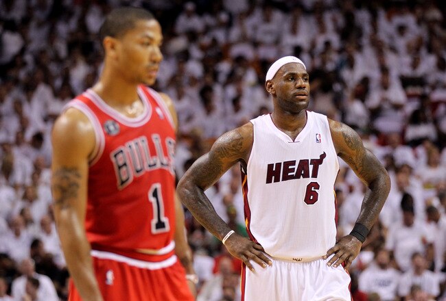MIAMI, FL - MAY 22:  LeBron James (R) #6 of the Miami Heat looks on as Derrick Rose #1 of the Chicago Bulls stands in the foregrouns in Game Three of the Eastern Conference Finals during the 2011 NBA Playoffs on May 22, 2011 at American Airlines Arena in Miami, Florida.  NOTE TO USER: User expressly acknowledges and agrees that, by downloading and or using this photograph, User is consenting to the terms and conditions of the Getty Images License Agreement.  (Photo by Mike Ehrmann/Getty Images)