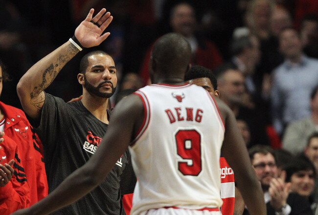 CHICAGO, IL - JANUARY 11: Carlos Boozer #5 of the Chicago Bulls greets Loul Deng #9 as he leaves a game against the Washington Wizards at the United Center on January 11, 2012 in Chicago, Illinois. The Bulls defeated the Wizards 78-64. NOTE TO USER: User expressly acknowledges and agrees that, by downloading and or using this photograph, User is consenting to the terms and conditions of the Getty Images License Agreement. (Photo by Jonathan Daniel/Getty Images)