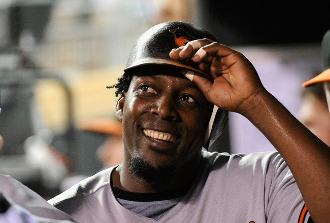 MINNEAPOLIS, MN - AUGUST 23: Vladimir Guerrero #27 of the Baltimore Orioles smiles in the dugout after scoring against the Minnesota Twins in the fifth inning on August 23, 2011 at Target Field in Minneapolis, Minnesota. (Photo by Hannah Foslien/Getty Images)