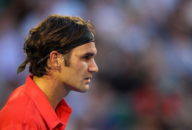 MELBOURNE, AUSTRALIA - JANUARY 22:  Roger Federer of Switzerlandlooks on in his fourth round match against  Bernard Tomic of Australia during day seven of the 2012 Australian Open at Melbourne Park on January 22, 2012 in Melbourne, Australia.  (Photo by Cameron Spencer/Getty Images)