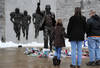 STATE COLLEGE, PA - JANUARY 22: Community members pay their respects at the statue of Joe Paterno, the former Penn State football coach, after hearing of Paterno's death outside of Beaver Stadium on January 22, 2012 in State College, Pennsylvania. Paterno, who was 85 years old, had been battling lung cancer. (Photo by Patrick Smith/Getty Images)