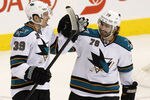 WINNIPEG, CANADA - JANUARY 12: Logan Couture #39 of the San Jose Sharks is congratulated by teammate Benn Ferriero #78 after his goal in the second period in NHL action at the MTS Centre on January 12, 2012 in Winnipeg, Manitoba, Canada. (Photo by Marianne Helm/Getty Images)