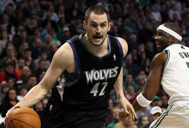 BOSTON, MA - JANUARY 03:  Kevin Love #42 of the Minnesota Timberwolves drives around Jermaine O'Neal #7 of the Boston Celtics on January 3, 2011 at the TD Garden in Boston, Massachusetts. The Celtics defeated the Timberwolves 96-93. NOTE TO USER: User expressly acknowledges and agrees that, by downloading and/or using this Photograph, User is consenting to the terms and conditions of the Getty Images License Agreement.  (Photo by Elsa/Getty Images)