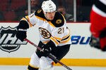 NEWARK, NJ - JANUARY 04:  Andrew Ference #21 of the Boston Bruins skates during an NHL hockey game against the New Jersey Devils at Prudential Center on January 4, 2012 in Newark, New Jersey.  (Photo by Paul Bereswill/Getty Images)