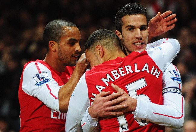 LONDON, ENGLAND - JANUARY 22:  Robin van Persie of Arsenal (R) celebrates with Theo Walcott (L)and Alex Oxlade-Chamberlain (C) as he scores their first goal during the Barclays Premier League match between Arsenal and Manchester United at Emirates Stadium on January 22, 2012 in London, England.  (Photo by Mike Hewitt/Getty Images)
