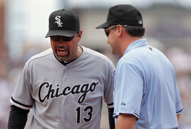 DENVER, CO - JUNE 30:  Manager Ozzie Guillen #13 of the Chicago White Sox protests a call with first base umpire Vic Carapazza after Seth Smith of the Colorado Rockies was called safe at first on a ground ball to first baseman Adam Dunn of the White Sox in the third inning during Interleague play at Coors Field on June 30, 2011 in Denver, Colorado.  (Photo by Doug Pensinger/Getty Images)