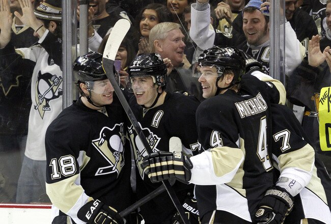 PITTSBURGH, PA - JANUARY 22:  Evgeni Malkin #71 of the Pittsburgh Penguins celebrates with James Neal #18 and Zbynek Michalek #4 after scoring the game winning goal in overtime against the Washington Capitals at Consol Energy Center on January 22, 2012 in Pittsburgh, Pennsylvania.  The Penguins defeated the Capitals 4-3 in overtime.  (Photo by Justin K. Aller/Getty Images)