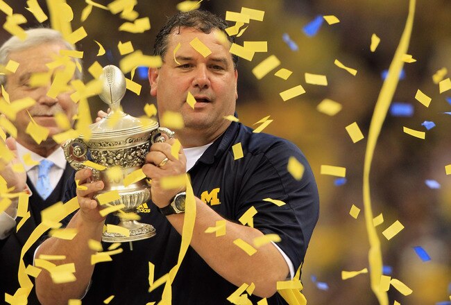 NEW ORLEANS, LA - JANUARY 03:  Head coach Brady Hoke of the Michigan Wolverines celebrates with the trophy after Michigan won 23-20 in overtime against the Virginia Tech Hokies during the Allstate Sugar Bowl at Mercedes-Benz Superdome on January 3, 2012 in New Orleans, Louisiana.  (Photo by Matthew Stockman/Getty Images)