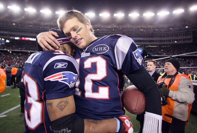 FOXBORO, MA - JANUARY 22:  Tom Brady #12 of the New England Patriots celebrates with teammate  Kevin Faulk #33 after defeating the Baltimore Ravens in the AFC Championship Game at Gillette Stadium on January 22, 2012 in Foxboro, Massachusetts. The New England Patriots defeated the Baltimore Ravens 20-23.  (Photo by Elsa/Getty Images)