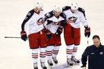 DALLAS, TX - DECEMBER 29:  James Wisniewski #21 of the Columbus Blue Jackets is helped off the ice by Jeff Carter #7 and Ryan Johansen #19 at American Airlines Center on December 29, 2011 in Dallas, Texas.  (Photo by Ronald Martinez/Getty Images)