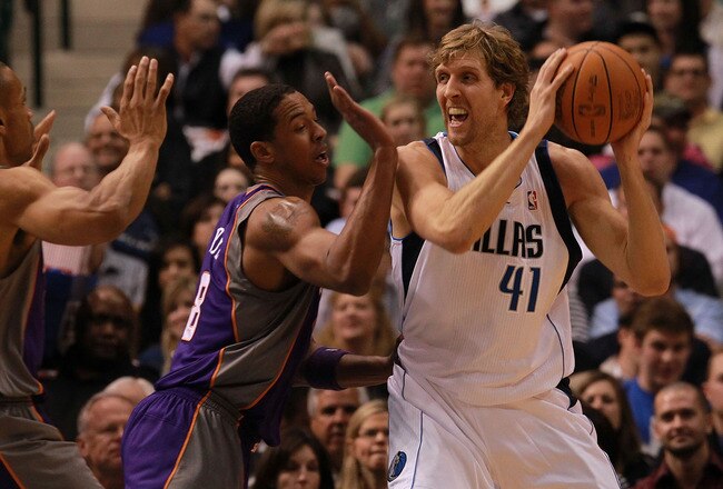 DALLAS, TX - JANUARY 04:  Dirk Nowitzki #41 of the Dallas Mavericks dribbles the ball against the Channing Frye #8 of the Phoenix Suns at American Airlines Center on January 4, 2012 in Dallas, Texas. Nowitzki was playing in his 1,000 career game.  NOTE TO USER: User expressly acknowledges and agrees that, by downloading and/or using this Photograph, user is consenting to the terms and conditions of the Getty Images License Agreement.  (Photo by Ronald Martinez/Getty Images)