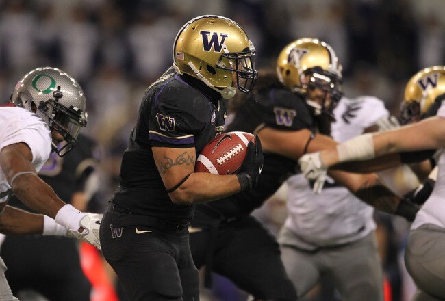 SEATTLE - NOVEMBER 05:  Running back Chris Polk #1 of the Washington Huskies rushes against the Oregon Ducks on November 5, 2011 at Husky Stadium in Seattle, Washington. Oregon won 34-17. (Photo by Otto Greule Jr/Getty Images)