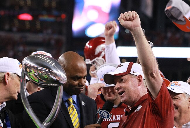 ARLINGTON, TX - JANUARY 06:  Head coach Bobby Petrino of the Arkansas Razorbacks celebrates the Cotton Bowl trophy after defeating the Kansas State Wildcats at Cowboys Stadium on January 6, 2012 in Arlington, Texas.  (Photo by Ronald Martinez/Getty Images)