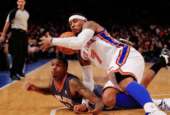 NEW YORK, NY - JANUARY 09:  Carmelo Anthony #7 of the New York Knicks competes for a loose ball with Tyrus Thomas #12 of the Charlotte Bobcats at Madison Square Garden on January 9, 2012 in New York City. NOTE TO USER: User expressly acknowledges and agrees that, by downloading and or using this photograph, User is consenting to the terms and conditions of the Getty Images License Agreement.  (Photo by Chris Trotman/Getty Images)