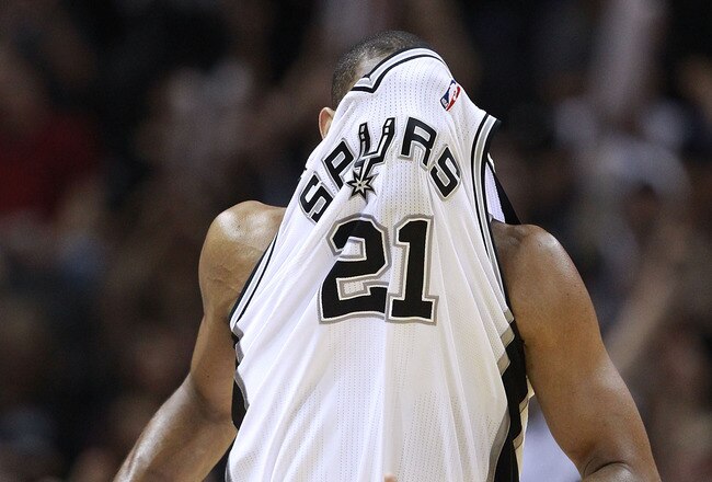 SAN ANTONIO, TX - APRIL 27:  Tim Duncan #21 of the San Antionio Spurs covers his face with his jersey after making a basket against the Memphis Grizzlies in Game Five of the Western Conference Quarterfinals in the 2011 NBA Playoffs on April 27, 2011 at AT&T Center in San Antonio, Texas. NOTE TO USER: User expressly acknowledges and agrees that, by downloading and or using this photograph, User is consenting to the terms and conditions of the Getty Images License Agreement.  (Photo by Jed Jacobsohn/Getty Images)