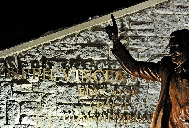 STATE COLLEGE, PA - JANUARY 22: Candles, many burnt out, circle the statue of Joe Paterno, the former Penn State football coach, outside of Beaver Stadium in the early hours of January 22, 2012 in State College, Pennsylvania. The community was reacting to news that Joe Paterno, who is suffering from lung cancer and who was fired in November in the aftermath of child sex abuse charges against a former assistant, was in serious condition. (Photo by Patrick Smith/Getty Images)