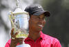 SAN DIEGO - JUNE 16:  Tiger Woods celebrates with the trophy after winning on the first sudden death playoff hole during the playoff round of the 108th U.S. Open at the Torrey Pines Golf Course (South Course) on June 16, 2008 in San Diego, California.  (Photo by Ross Kinnaird/Getty Images)