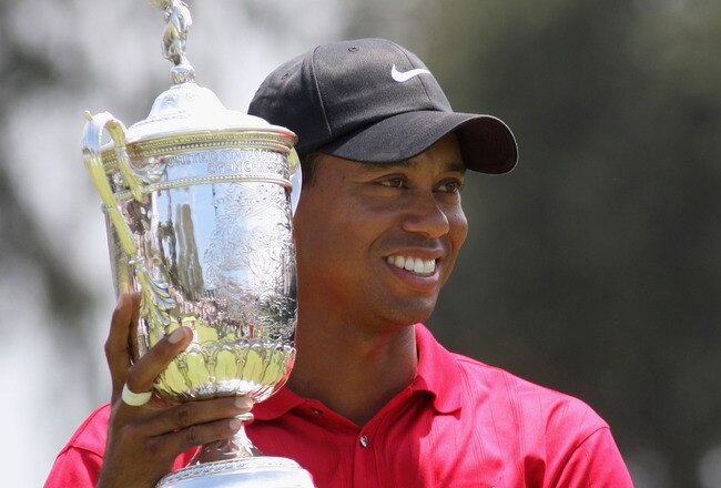 SAN DIEGO - JUNE 16:  Tiger Woods celebrates with the trophy after winning on the first sudden death playoff hole during the playoff round of the 108th U.S. Open at the Torrey Pines Golf Course (South Course) on June 16, 2008 in San Diego, California.  (Photo by Ross Kinnaird/Getty Images)