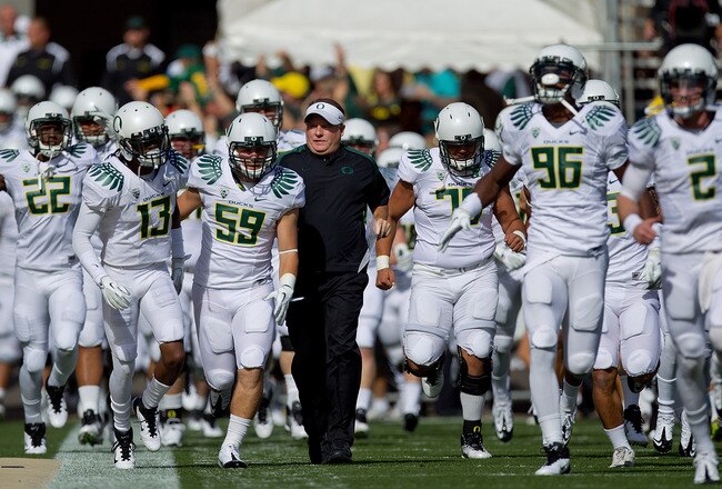 BOULDER, CO - OCTOBER 22:  Head Coach Chip Kelly of the Oregon Ducks leads his team on to the field before taking on the Colorado Buffaloes at Folsom Field on October 22, 2011 in Boulder, Colorado. (Photo by Justin Edmonds/Getty Images)
