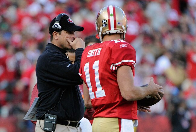 SAN FRANCISCO, CA - JANUARY 14:  Head coach Jim Harbaugh of the San Francisco 49ers talks with quarterback Alex Smith #11 in the third quarter against the New Orleans Saints during the NFC Divisional playoff game at Candlestick Park on January 14, 2012 in San Francisco, California.  (Photo by Thearon W. Henderson/Getty Images)