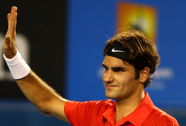 MELBOURNE, AUSTRALIA - JANUARY 22:  Roger Federer of Switzerland thanks the crowd after winning his fourth round match against  Bernard Tomic of Australia during day seven of the 2012 Australian Open at Melbourne Park on January 22, 2012 in Melbourne, Australia.  (Photo by Mark Dadswell/Getty Images)