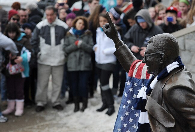 STATE COLLEGE, PA - JANUARY 22: Community members pay their respects at the statue of Joe Paterno, the former Penn State football coach, after hearing of Paterno's death, outside of Beaver Stadium on January 22, 2012 in State College, Pennsylvania. Paterno, who was 85 years old, died due to complications from lung cancer. (Photo by Patrick Smith/Getty Images)