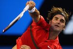 MELBOURNE, AUSTRALIA - JANUARY 22:  Roger Federer of Switzerland serves in his fourth round match against Bernard Tomic of Australia during day seven of the 2012 Australian Open at Melbourne Park on January 22, 2012 in Melbourne, Australia.  (Photo by Cameron Spencer/Getty Images)