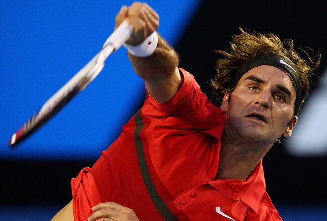 MELBOURNE, AUSTRALIA - JANUARY 22:  Roger Federer of Switzerland serves in his fourth round match against Bernard Tomic of Australia during day seven of the 2012 Australian Open at Melbourne Park on January 22, 2012 in Melbourne, Australia.  (Photo by Cameron Spencer/Getty Images)
